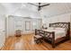 Bright main bedroom featuring a vaulted ceiling, wood floors, and a unique branch-style bed frame at 3903 Hazelhurst Dr, Marietta, GA 30066