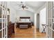 Bedroom with wood floors, ceiling fan and french doors leading to more of the house at 3903 Hazelhurst Dr, Marietta, GA 30066