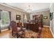 Elegant home office with rich wood finishes, a large desk, and custom window treatments at 3903 Hazelhurst Dr, Marietta, GA 30066