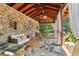 Inviting covered stone patio featuring comfortable seating and a rustic stone wall, perfect for outdoor relaxation at 3903 Hazelhurst Dr, Marietta, GA 30066
