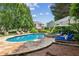 A backyard in-ground pool and spa feature flagstone decking, poolside seating, and landscaping at 3903 Hazelhurst Dr, Marietta, GA 30066