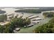 Expansive aerial view of lakefront property featuring numerous boat docks and lush green surroundings at 657 Summit Hill Way, Cumming, GA 30040