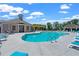 Community pool with zero entry, lounge chairs, seating, and pool house for residents to enjoy at 657 Summit Hill Way, Cumming, GA 30040