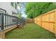 Backyard features manicured lawn and wood fence for privacy at 1090 Mcdaniel St, Atlanta, GA 30310
