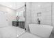 Bathroom featuring a freestanding tub, double vanity, and tiled shower at 1090 Mcdaniel St, Atlanta, GA 30310