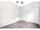 A bedroom is shown with light gray walls, wood-look floors and double bi-fold closet doors at 1090 Mcdaniel St, Atlanta, GA 30310