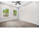 Bright bedroom with hardwood floors, a ceiling fan, and large windows at 1090 Mcdaniel St, Atlanta, GA 30310