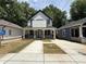 Charming two-story home features a front porch, large driveway, and mature trees at 1090 Mcdaniel St, Atlanta, GA 30310