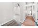 Hallway with light gray walls and gray wood-look flooring leading to a bright room at 1090 Mcdaniel St, Atlanta, GA 30310