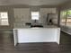 Bright kitchen boasts white cabinetry, stone countertops, and a stainless steel refrigerator at 1090 Mcdaniel St, Atlanta, GA 30310