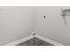 A corner laundry area features hook ups and modern gray paint and light wood-look floors at 1090 Mcdaniel St, Atlanta, GA 30310