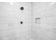 Modern shower features white marble tile, matte black fixtures, and convenient built-in shelving at 1090 Mcdaniel St, Atlanta, GA 30310