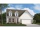 Charming two-story home with brick accents, white siding, dormer windows, and an attached two-car garage at 164 Henley St, Canton, GA 30114
