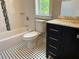 Bathroom with tiled floors, bathtub and shower, and sink vanity with marble countertop at 339 Morgan Se Pl, Atlanta, GA 30317