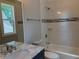 Bathroom features tiled shower-tub and marble sink at 339 Morgan Se Pl, Atlanta, GA 30317
