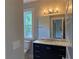Bathroom featuring vanity with marble countertop and black and white mosaic floors at 339 Morgan Se Pl, Atlanta, GA 30317
