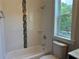 Bright bathroom features a shower over tub and window at 339 Morgan Se Pl, Atlanta, GA 30317