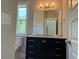 Bathroom with vanity featuring marble countertop, black cabinets, and mosaic floors at 339 Morgan Se Pl, Atlanta, GA 30317