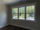 Bedroom featuring three large windows with bright natural light and hardwood floors at 339 Morgan Se Pl, Atlanta, GA 30317
