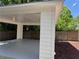 Attached carport featuring lighting and a wooden privacy fence offers parking and protection from the elements at 339 Morgan Se Pl, Atlanta, GA 30317