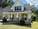 Attractive two-story home with a covered porch, brick-base columns and manicured landscaping at 339 Morgan Se Pl, Atlanta, GA 30317