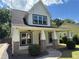 Inviting two-story home with a covered porch, brick columns and lush landscaping at 339 Morgan Se Pl, Atlanta, GA 30317
