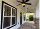 Covered porch showcasing stylish lighting fixtures, fan, and brick flooring for a cozy outdoor space at 339 Morgan Se Pl, Atlanta, GA 30317