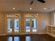 Bright room with double doors to the outside, hardwood floors, and built-in shelving at 339 Morgan Se Pl, Atlanta, GA 30317