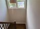 View from the top of a hardwood staircase with rod iron railings and a large window at 339 Morgan Se Pl, Atlanta, GA 30317