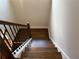 Hardwood steps lead down this well-lit staircase with rod iron railings at 339 Morgan Se Pl, Atlanta, GA 30317
