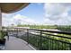 Spacious balcony showcasing city and wooded views from behind black iron railings at 3445 Stratford Ne Rd # 903, Atlanta, GA 30326