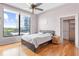 A stylish bedroom with hardwood floors and large windows providing ample natural light and city views at 3445 Stratford Ne Rd # 903, Atlanta, GA 30326