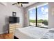 Bedroom boasting a large window with city and wooded views, complemented by a ceiling fan at 3445 Stratford Ne Rd # 903, Atlanta, GA 30326