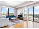 Airy living room boasting hardwood floors, large windows, and sliding glass doors to a balcony at 3445 Stratford Ne Rd # 903, Atlanta, GA 30326