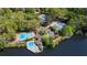 Aerial view of community pools, tennis courts, parking, and lake access surrounded by mature trees at 4018 Dunbarton Ne Way, Roswell, GA 30075