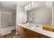 Bright bathroom with wooden vanity, large mirror, and updated shower/tub at 4018 Dunbarton Ne Way, Roswell, GA 30075