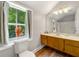 Bathroom featuring wood-look floors, a window view, and traditional vanity at 4018 Dunbarton Ne Way, Roswell, GA 30075