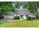 Charming home with a well-maintained lawn, mature trees, and a two-car garage at 4018 Dunbarton Ne Way, Roswell, GA 30075