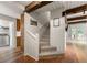 Bright hallway featuring wooden beams, a staircase, and access to the laundry room at 4018 Dunbarton Ne Way, Roswell, GA 30075