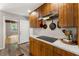 Kitchen with wooden cabinets, stone countertops, and stainless steel appliances at 4018 Dunbarton Ne Way, Roswell, GA 30075