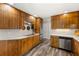 Spacious kitchen with wooden cabinets, stainless steel appliances, and vinyl floors at 4018 Dunbarton Ne Way, Roswell, GA 30075