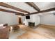 Open living room featuring exposed beams, a fireplace, and hardwood floors at 4018 Dunbarton Ne Way, Roswell, GA 30075