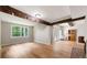 Bright living room featuring exposed beams, hardwood floors, and backyard views at 4018 Dunbarton Ne Way, Roswell, GA 30075