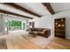 Bright living room with exposed beams, hardwood floors, and access to the deck at 4018 Dunbarton Ne Way, Roswell, GA 30075