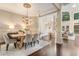 Elegant dining room with hardwood floors, stylish chandelier, and plenty of natural light at 110 Wellington Way, Canton, GA 30115