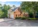 Exterior home view showcasing brick and neutral siding, an attached garage and beautiful landscaping at 110 Wellington Way, Canton, GA 30115