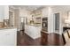 Bright kitchen featuring white cabinets, stainless steel appliances, granite countertops and wood flooring at 110 Wellington Way, Canton, GA 30115