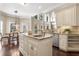 Open kitchen featuring a granite island, stainless steel appliances, and dining area at 110 Wellington Way, Canton, GA 30115