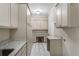 Well-lit laundry room with ample cabinet space and granite countertops at 110 Wellington Way, Canton, GA 30115