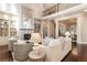 Bright living room with high ceilings, fireplace, built-in shelving, and hardwood floors at 110 Wellington Way, Canton, GA 30115